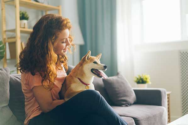 Woman Hugs a Dog at Home — Lakeland, FL — Family Insurance Centers